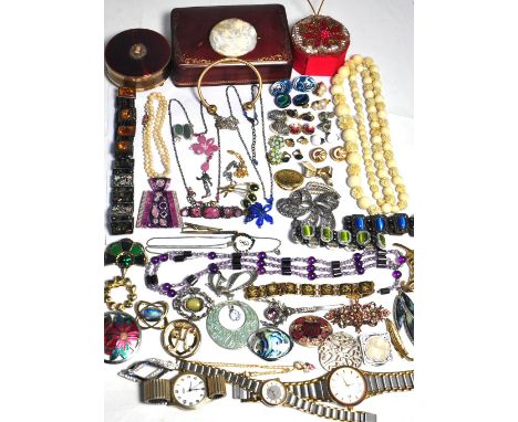 A leather case containing a small quantity of costume jewellery to include a white metal marcasite brooch, a yellow metal ban