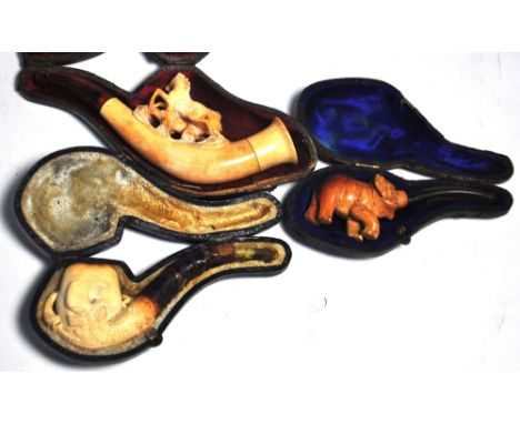 A late Victorian cased carved meerschaum pipe modelled as an elephant, the mouthpiece being the elephants trunk, a further ca