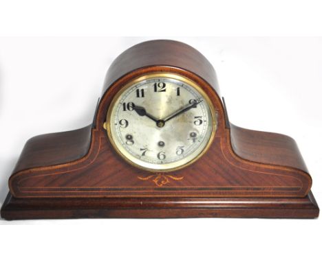 An early 20th century mahogany chevron strung and inlaid Napoleon hat mantel clock with circular silvered dial set with Arabi