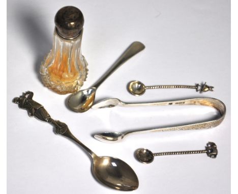 A George V hallmarked silver spoon with a golfer finial, Birmingham 1929, a pair of silver sugar tongs Sheffield 1907, a cut-