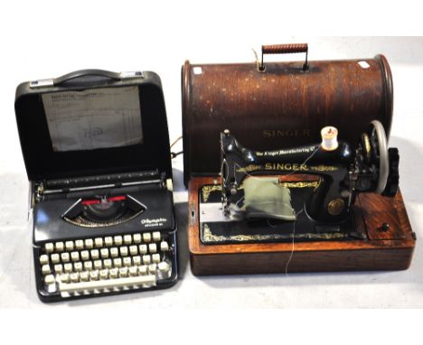 An oak cased Singer sewing machine and a vintage typewriter in case (2).