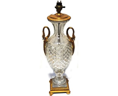 A continental cut glass gilt metal mounted table lamp with scrolling swan neck handle and stepped base, height 48cm.