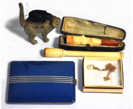 A white metal pin cushion in the form of a cat, a cased ivory cigarette holder, a long ivory cigarette holder, a compact and 