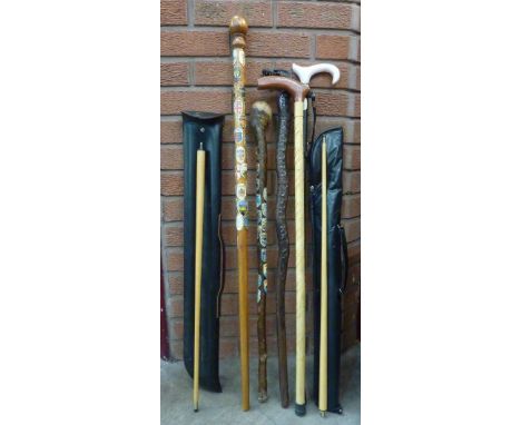 Walking sticks and two cues, one stick with carved dragon's head