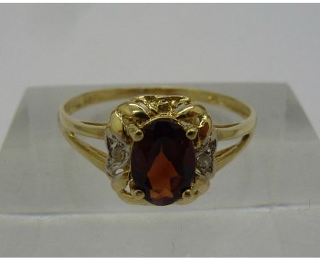 A 9ct gold, diamond and garnet ring, weight 1.1g, size N