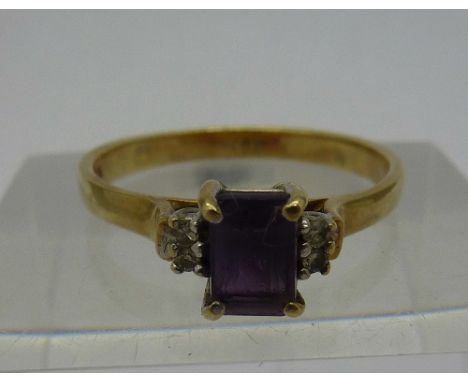 A 9ct gold, purple stone and four diamond ring, weight 2.2g, size O