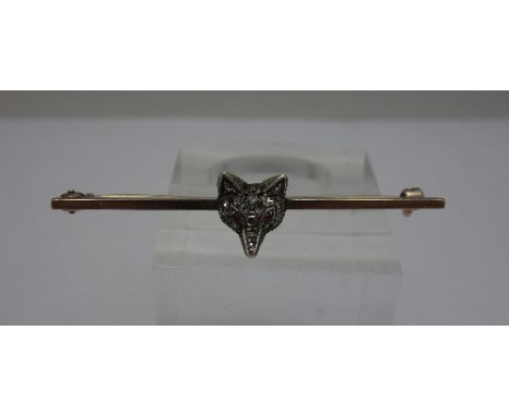 A diamond set fox head brooch with ruby eyes