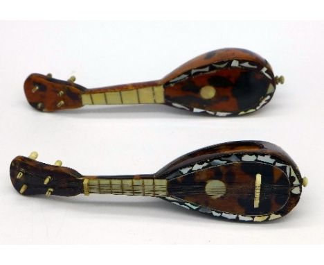 Two small tortoiseshell banjos with mother of pearl inlay