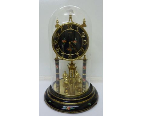 A Kundo black enamel dial anniversary clock with glass dome and stand