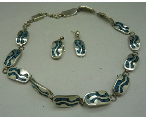 A silver and enamel necklace and a pair of matching earrings