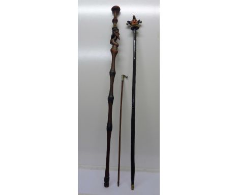 A Jester stick, a carved African stick and a riding crop