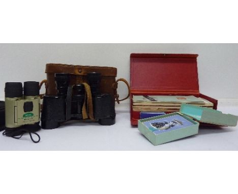 A pair of binoculars, field glasses, a bridge set and playing cards