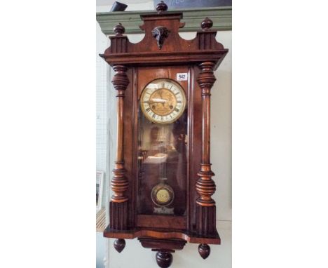 A late Victorian striking Vienna style wall clock in walnut and glazed case 