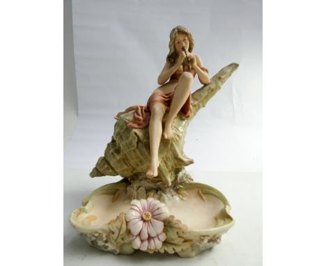 A Royal Dux figure of a Siren playing pipes seated on a shell with floral decorated dish below, pink triangle mark numbered 5