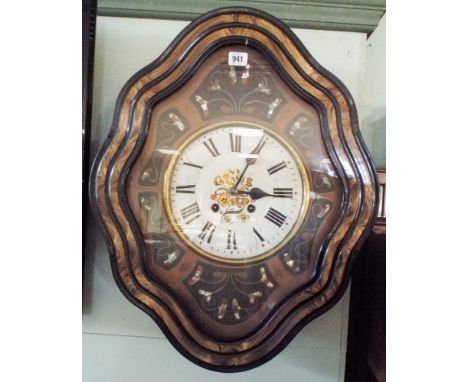 A decorative shaped French wall clock inset with Mother of Pearl with painted dial Includes pendulum and key.     Condition -