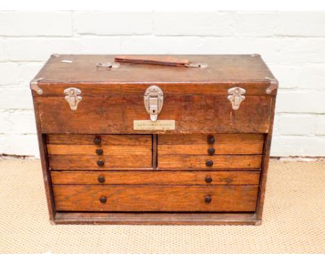 A portable tool chest with lift up lid and interior drawers full of assorted engineering tools mainly by Moore & Wright 