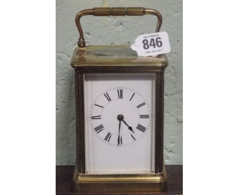 A large French carriage clock with white enamel dial and brass and glass case      Serial number is 7002
