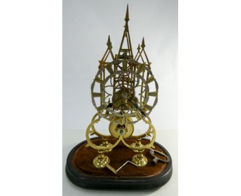 A Victorian brass skeleton clock with fusee movement under glass dome - recently serviced