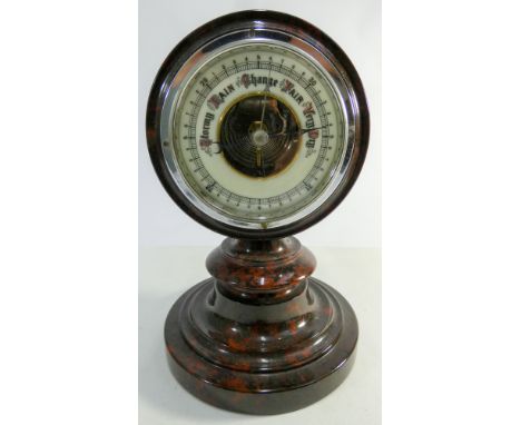 A table top barometer in red mottled marble case 