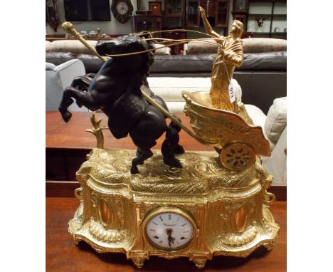 A very large brass clock, mounted with Boudica upon a 2 horse chariot to the top     1. It is ticking 