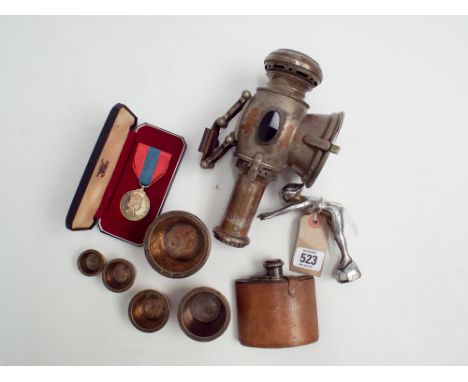 A Chrome car mascot old acetylene bicycle lamp together with a leather covered hip flask, imperial service medal and weights 