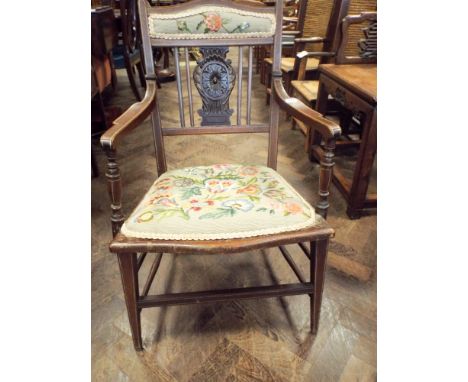 An Edwardian mahogany elbow chair with tapestry upholstered seat and back pad
