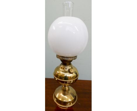 A brass oil lamp with white bowl shade 