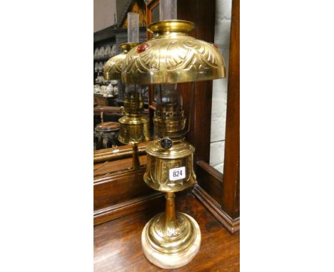 Decorative brass oil lamp on a marble plinth 