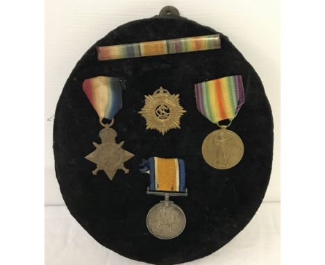 A WWI medal trio together with ribbon bar and Army Service Corps cap badge. Comprising; British War Medal, Victory Medal and 