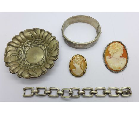 A bangle marked silver, 32g, an .835 silver mounted cameo, a base metal mounted cameo, a white metal bracelet, 33.3g and a si