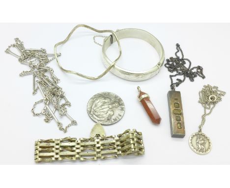 A silver bangle, a silver ingot pendant, a gate bracelet, etc.