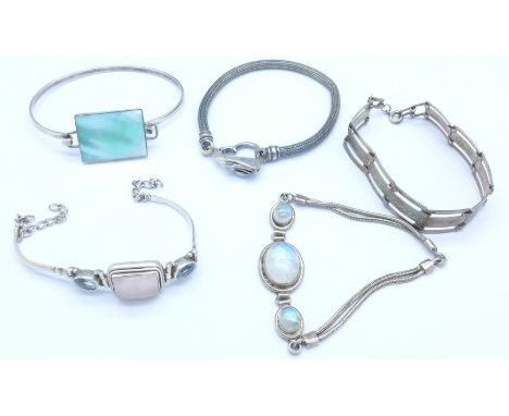 Four silver bracelets and a bangle