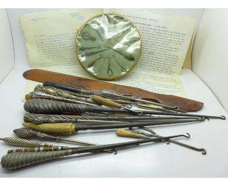 A collection of button hooks, including silver handled, ivory, ebony, tortoiseshell and steel handles, one set in a circular 