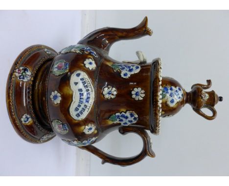 A bargeware teapot and stand with 'A Present From A Friend' cartouche and a miniature bargeware teapot, lid restored on large
