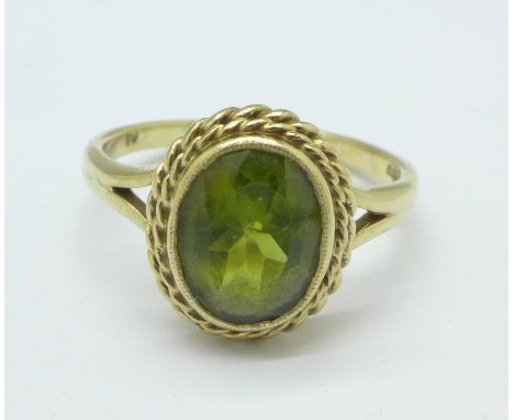 A 9ct gold and green stone ring, 4.1g, R