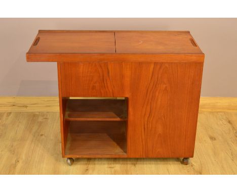 A DANISH TEAK DRINKS TROLLEY, the double sliding top revealing a red velvet interior, above a single drawer to the side with 