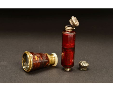 A LATE VICTORIAN RUBY GLASS DOUBLE ENDED SCENT BOTTLE, of decagonal form, one end with hinged white metal cover, the other en