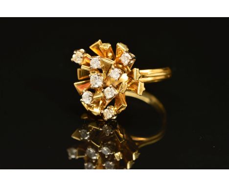 A 1970'S 18CT GOLD ABSTRACT DIAMOND SET RING, designed as spokes claw set with brilliant cut diamonds, interspaced by angled 