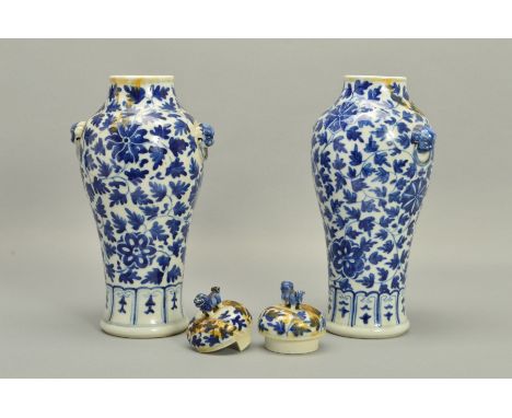 A PAIR OF CHINESE PORCELAIN BALUSTER VASES AND COVERS, decorated in underglaze blue with trailing foliage and lotus flowers, 