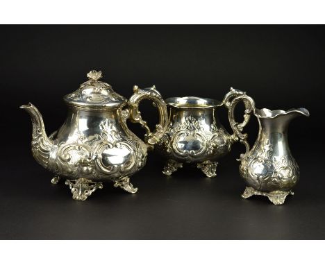 A VICTORIAN SILVER THREE PIECE TEASET, of baluster form, the teapot with flower head finial, ivory insulators to teapot handl