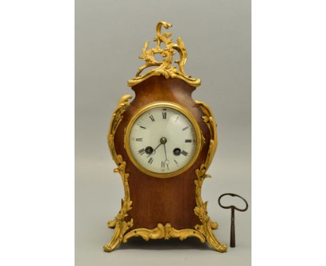 AN EARLY 20TH CENTURY FRENCH LOUIS XIV STYLE WALNUT CASED MANTEL CLOCK WITH ORMOLU MOUNTS, enamel dial with Roman numerals an