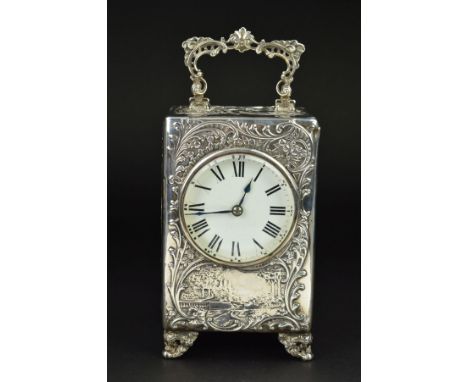 AN EDWARDIAN SILVER CASED BOUDOIR OR CARRIAGE TIMEPIECE, the top with hinged carrying handle cast and pierced with scrolls, t