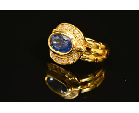 A MODERN SAPPHIRE AND DIAMOND OVAL CLUSTER RING, oval mixed cut sapphire measuring approximately 8.7mm x 5.7mm, estimated wei
