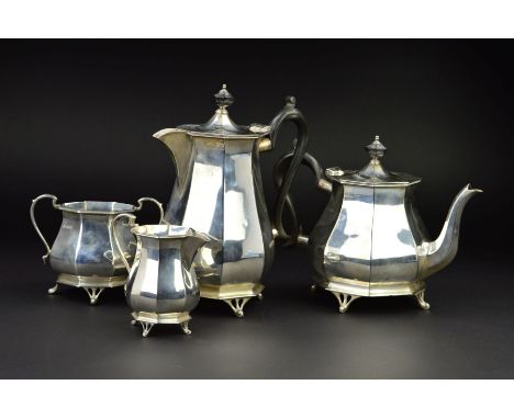 A GEORGE V SILVER FOUR PIECE TEA SERVICE, of octagonal baluster form, 'S' scroll handles, ebony fitments to teapot and hot wa