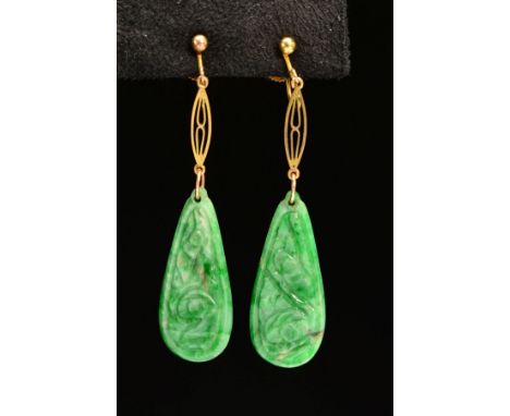 AN EARLY 20TH CENTURY PAIR OF CARVED JADE DROP EARRINGS, each pear shaped jadite carved in a floral design, measuring approxi