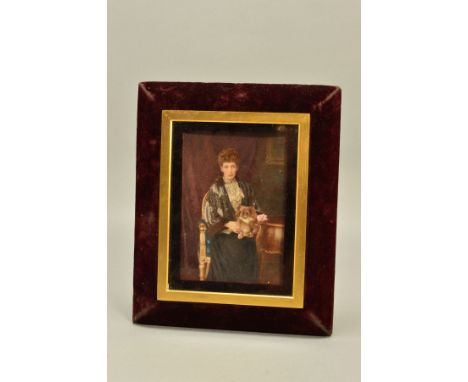A LATE 19TH/EARLY 20TH CENTURY PORTRAIT MINIATURE OF A LADY SEATED WITH A DOG ON HER LAP, reputedly Queen Alexandra, within a