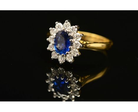 A MODERN 18CT GOLD SAPPHIRE AND DIAMOND OVAL CLUSTER RING, oval blue sapphire measuring approximately 6.3mm x 5.1mm, sapphire