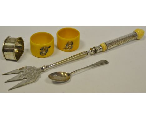 A silver napkin ring; others ivorine; a silver teaspoon; a roasting fork silver ferrule (5)