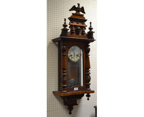 An early 20th Century mahogany drop pendulum wall clock, eagle finial