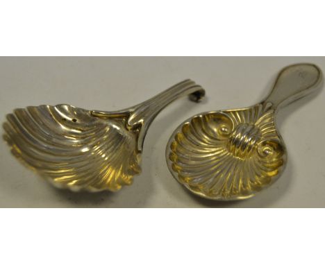 An early 19th century silver caddy spoon, as a scallop shell,  Birmingham 1835; another similar caddy spoon (2)
